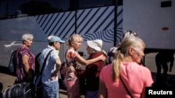 FILE: Civilians prepare to board a bus to Germany, as Russia's attack on Ukraine continues, in Kramatorsk, Ukraine. Taken 8.8.2022