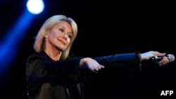 FILE - Singer Olivia Newton-John performs at the 58th Vina del Mar International Song Festival in Vina del Mar, Chile, Feb. 23, 2017.