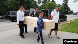 Pallbears carry remains of Ophelia Powless into Holy Apostles Church on the Oneida Nation, Oneida, Wi., June 30, 2019.