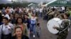 Venezuelans pass Colombian soldiers as they cross into Colombia over the Simon Bolivar international bridge in Cucuta, Colombia, Aug. 13, 2016.