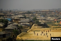 FILE - Rohingya refugees play football at Kutupalong refugee camp in Cox's Bazaar, Bangladesh, March 27, 2018.