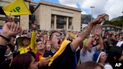 Supporters of President Gustavo Petro cheer during his televised inauguration ceremony, at the Bolivar square, in Bogota, Colombia, Aug. 7, 2022.