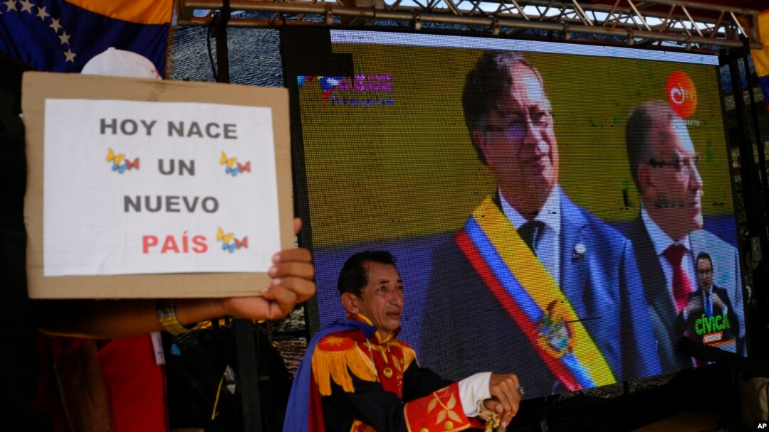 Colombia's new President Gustavo Petro is seen on a giant TV screen during his swearing-in ceremony in San Antonio, on the Venezuelan border with Colombia, Aug. 7, 2022.