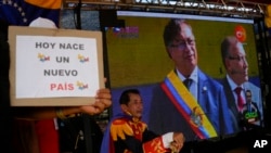 Colombia's new President Gustavo Petro is seen on a giant TV screen during his swearing-in ceremony in San Antonio, on the Venezuelan border with Colombia, Aug. 7, 2022.