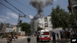 Smoke rises after Israeli airstrikes on residential building, in Gaza City, Aug. 6, 2022.