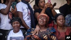Mourners gather around coffins containing the remains of residents who died during protests against the United Nations mission to the Democratic Republic of Congo in Goma.