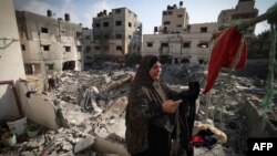 Palestinka prostire odeću ispred svog doma oštećenog u izraelskom vazdušnom udaru na grad Gazu prošle nedelje, nekoliko sati pošto što je stupilo na snagu primirje između Izraela i palestinskih militanata, 8. avgusta 2022.