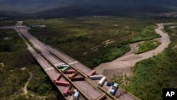 FILE - Containers block the Tienditas International Bridge, seen from Cucuta, Colombia, which connects with Tienditas, Venezuela, Aug. 5, 2022.