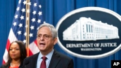 Attorney General Merrick Garland, with Assistant Attorney General Kristen Clarke for the Civil Rights Division, speaks during a news conference at the Department of Justice in Washington, Aug. 4, 2022. 