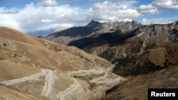 FILE - A general view shows the road linking southern Kyrgyzstan and China near the Kyrgyz town of Osh, Oct. 16, 2006.