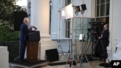 President Joe Biden speaks from the Blue Room Balcony of the White House, Aug. 1, 2022, a precaution taken after he continued to test positive for COVID-19. Biden was announcing that a U.S. airstrike killed al-Qaida leader Ayman al-Zawahri in Afghanistan.