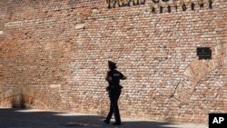  A police officer walkes in front of the Palais Coburg where closed-door nuclear talks take place in Vienna, Austria, Aug. 5, 2022.