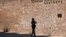  A police officer walkes in front of the Palais Coburg where closed-door nuclear talks take place in Vienna, Austria, Aug. 5, 2022.