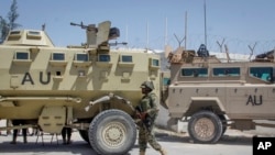 FILE - An African Union peacekeeper from Uganda provides security as Somali lawmakers arrive to cast their vote in the presidential election, at the Halane military camp in Mogadishu, May 15, 2022. 