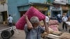 A porter carries a sacks of imported onions at a market place in Colombo, Sri Lanka, July 29, 2022.Sri Lanka