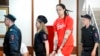 FILE - WNBA star and two-time Olympic gold medalist Brittney Griner is escorted to a courtroom for a hearing, in Khimki outside Moscow, July 7, 2022.