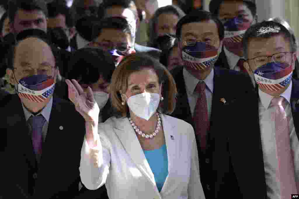 Visiting U.S. House Speaker Nancy Pelosi (C) waves to journalists during her arrival at the Parliament in Taipei, Taiwan.