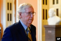FILE - Senate Minority Leader Mitch McConnell walks to his office on Capitol Hill in Washington, Aug. 6, 2022.