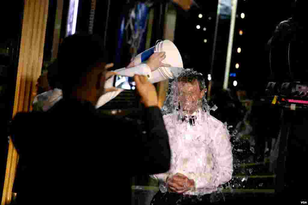 Seth Meyers takes the ice bucket challenge backstage at the 66th Primetime Emmy Awards at the Nokia Theatre in Los Angeles L.A. Live, Aug. 25, 2014, in Los Angeles.