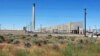 FILE--The Plutonium Uranium Extraction Plant (R) stands adjacent to a dirt-covered rail tunnel (L) containing radioactive waste, amidst desert plants on the Hanford Nuclear Reservation near Richland, Wash., June 13, 2017. 