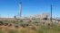 FILE--The Plutonium Uranium Extraction Plant (R) stands adjacent to a dirt-covered rail tunnel (L) containing radioactive waste, amidst desert plants on the Hanford Nuclear Reservation near Richland, Wash., June 13, 2017. 