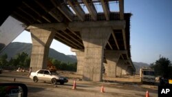 FILE - Work continues on a new international trade route near Havalian in Pakistan, May 11, 2017. The work is part of a sprawling Chinese initiative to build a "new Silk Road" of ports, railways and roads across Asia, Africa and Europe.