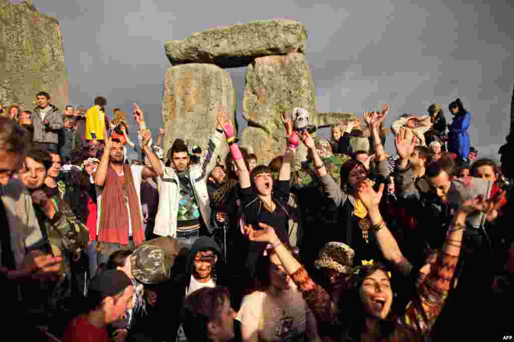 June 21: Revellers cheer as the sun breaks through the clouds during the summer solstice at Stonehenge, near Salisbury in England. The summer solstice in the northern hemisphere occurs annually on June 21; the time at which the sun is at its northernmost 