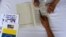 A supporter of Venezuela's President Nicolas Maduro signs a petition against the U.S. sanctions on Venezuela during a gathering in Caracas, Venezuela August 11, 2019. 
