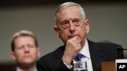 FILE - Defense Secretary Jim Mattis listens while testifying before the Senate Armed Services Committee hearing on the Pentagon's budget, on Capitol Hill in Washington, June 13, 2017.