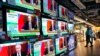 People stand by TV screens broadcasting the news of Russia's invasion of Ukraine, in Hong Kong, Feb. 24, 2022. (AP/Vincent Yu)