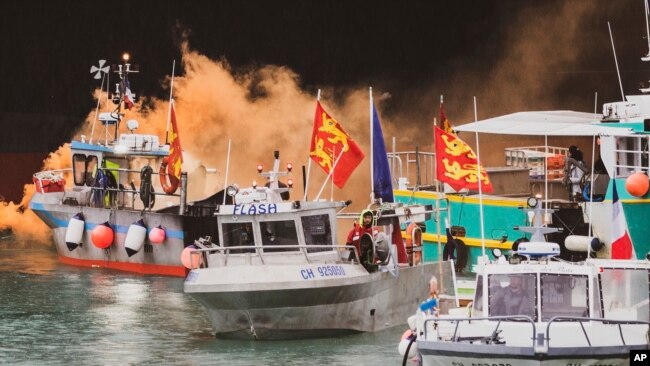 FILE - Fishing vessels at sea off the coast of Jersey, May 6, 2021. This week France rallied EU partners for a joint stance and action if London won't grant more licenses for small French fishing boats to roam close to the U.K.