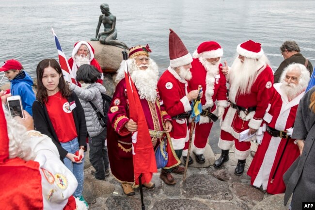 Participants of the Santa Claus World Congress visit the Little Mermaid statue in Copenhagen, Denmark.