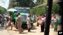 Woman prisoners carrying their belongings walk toward the entrance gate as they were released from Insein prison Tuesday, April 17, 2018, Yangon, Myanmar. Myanmar President Win Myint has granted amnesty to more than 8,500 prisoners, reportedly including at least three dozen polit