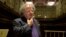 FILE - James Levine pauses as he looks over the stage and conductor's podium in Boston's Symphony Hall after being announced as the next conductor and music director of The Boston Symphony Orchestra, in Boston, Massachusetts, U.S., Oct. 29, 2001. 
