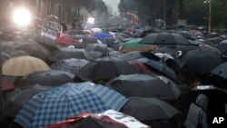 Protesters take part in a rally in Tirana, May 13, 2019. Anti-government protesters in Albania hurled firebombs and flares at riot police standing in front of the main government building.