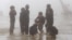FILE - Children play during a class break on a foggy day, located on the China border on Sept. 21, 2015. Parents grew anxious after nearly 500 students from a middle school developed illnesses that are possibly linked contaminated soil and underground water adjacent to three former pesticide plants.