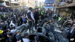 Lebanese citizens gather at the site of a car bombing in a southern suburb of Beirut, Lebanon, Jan. 21, 2014 (AP Photo/Bilal Hussein)