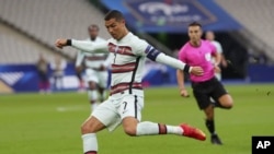 Portugal's Cristiano Ronaldo attempts a shot at goal during the UEFA Nations League soccer match between France and Portugal at the Stade de France in Saint-Denis, north of Paris, France, Sunday, Oct. 11, 2020. (AP Photo/Thibault Camus)