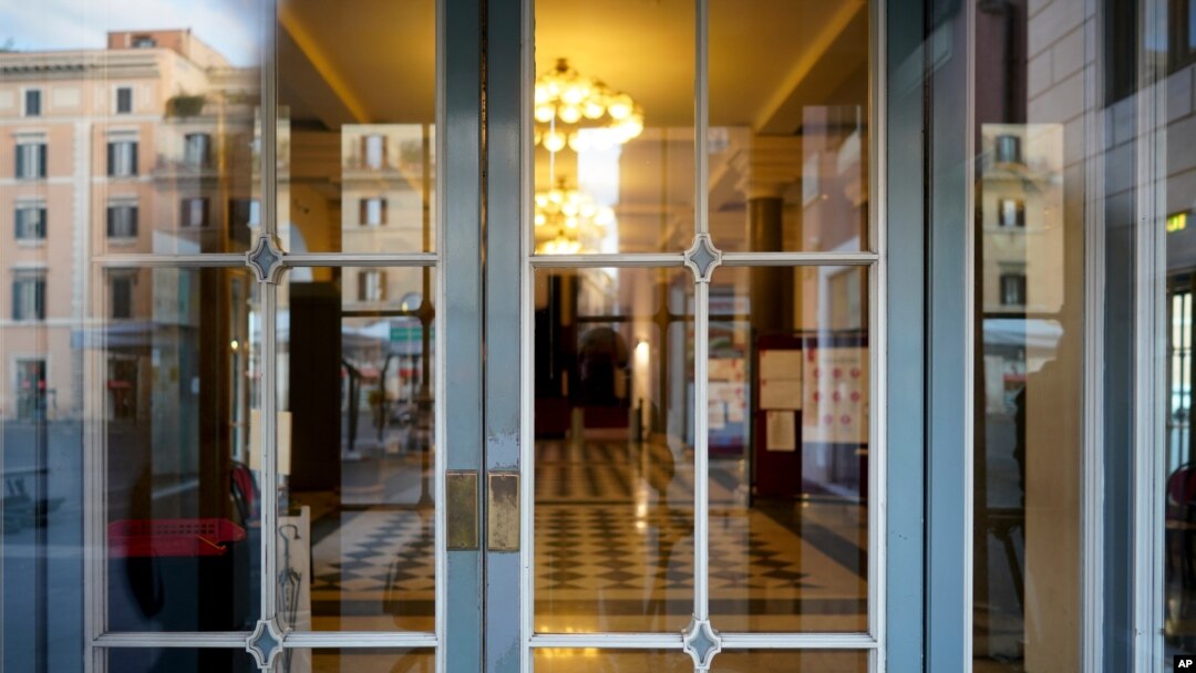 The foyer of the closed Argentina theater is seen through its locked entrance, in Rome, Oct. 26, 2020. 