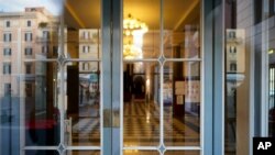 The foyer of the closed Argentina theater is seen through its locked entrance, in Rome, Oct. 26, 2020. 