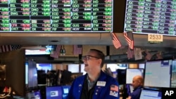 Traders work on the floor at the New York Stock Exchange in New York, Nov. 10, 2022.