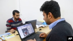 An employee at a photography institute checks his Facebook account in Dhaka, Bangladesh, Thursday, Dec. 20, 2018. 