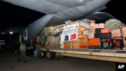 In this photo released by Inter Services Public Relations, Pakistan Air Force crew load supplies of assistance package for earthquake-hit areas of Turkey, into a plane at Nur Khan airbase in Rawalpindi, Pakistan, Feb. 7, 2023.