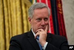 White House chief of staff Mark Meadows listens during a meeting on the coronavirus response between President Donald Trump and Gov. Ron DeSantis, R-Fla., in the Oval Office of the White House, Tuesday, April 28, 2020, in Washington. (AP Photo/Evan…