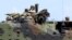 FILE - U.S. Marines from the 3rd Marine Expeditionary Brigade ride on an amphibious assault vehicle during assault exercises with Philippine marine troops in joint drills.