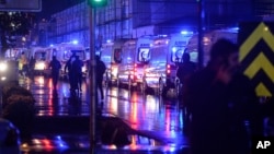 FILE - Ambulances wait near the scene of an attack in Istanbul, early Jan. 1, 2017.