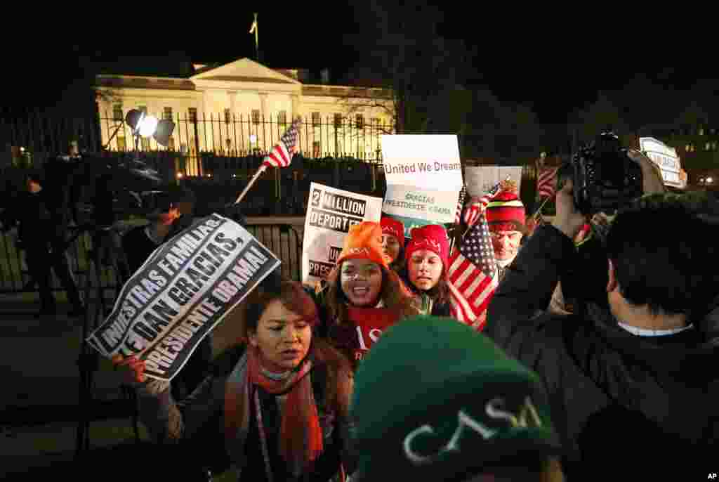 People chant during a demonstration in front of the White House as President Barack Obama announced executive actions on immigration during a nationally televised address, in Washington, Nov. 20, 2014.