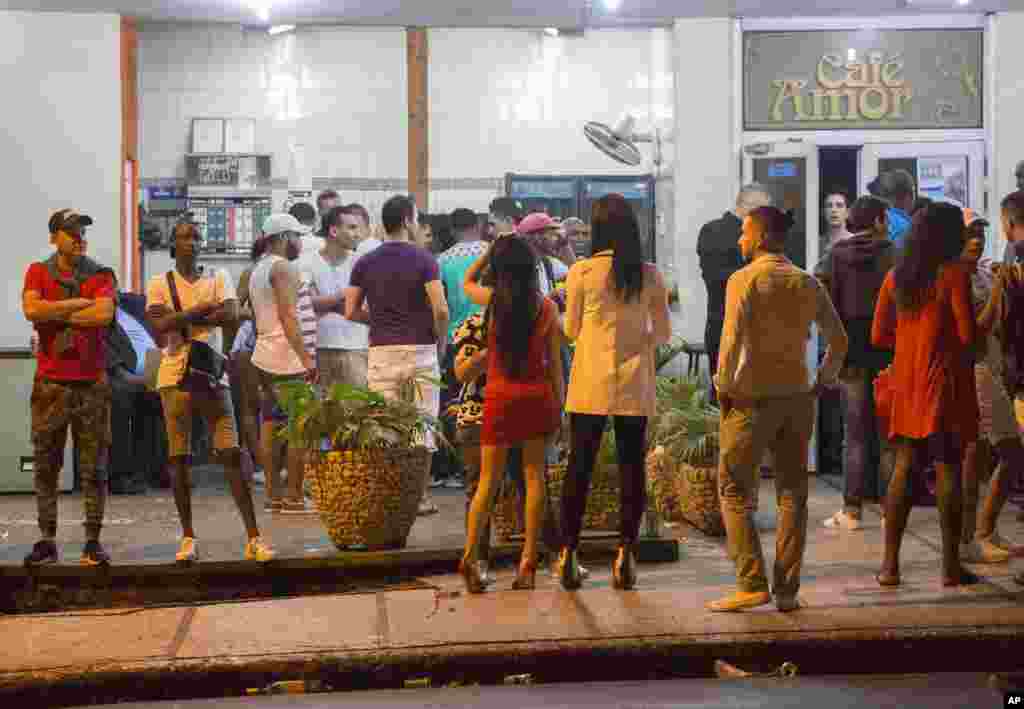 People stand in the street after nightclubs were closed by authorities in Havana, Cuba, early Saturday, Nov. 26, 2016. Former President Fidel Castro, who led a rebel army to improbable victory in Cuba, embraced Soviet-style communism.