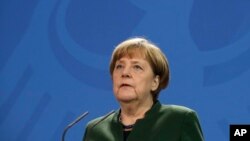 German Chancellor Angela Merkel gives a statement prior to a meeting with Ukrainian President Petro Poroshenko in Berlin, Germany, Monday, Jan. 30, 2017. 