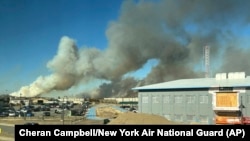 This photo provided by the New York Air National Guard shows smoke from the fires in the Pine Barrens off Sunrise Highway in New York's Long Island, March 8, 2025.